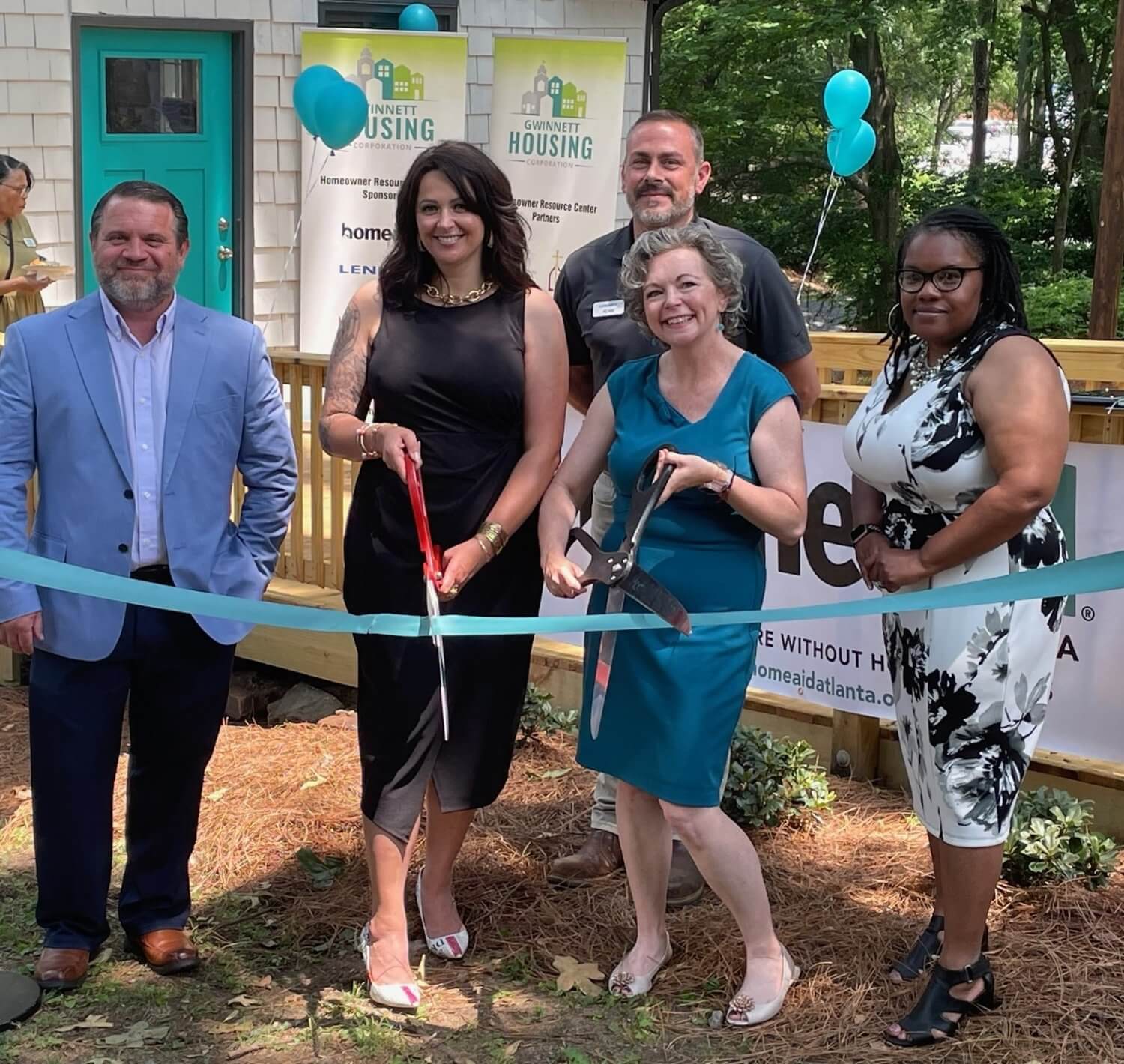 Representatives of Lennar, HomeAid Atlanta, & Gwinnett Housing Corporation cut the ribbon at the Homeowner Resource Center on June 5 in Norcross. (L-R) Tom Bowers, Lennar VP of Operations; Lejla Prljaca, GHC Executive Director; Adam Paterson, Lennar Area Construction Manager; Mandy Crater, HomeAid Atlanta Executive Director; Karen Ramsey, GHC Director of Housing Initiatives.